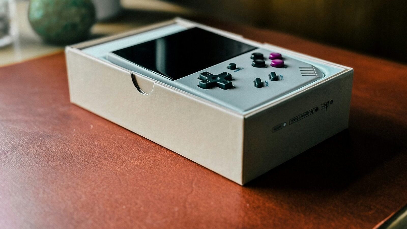 A nintendo wii controller sitting on top of a wooden table